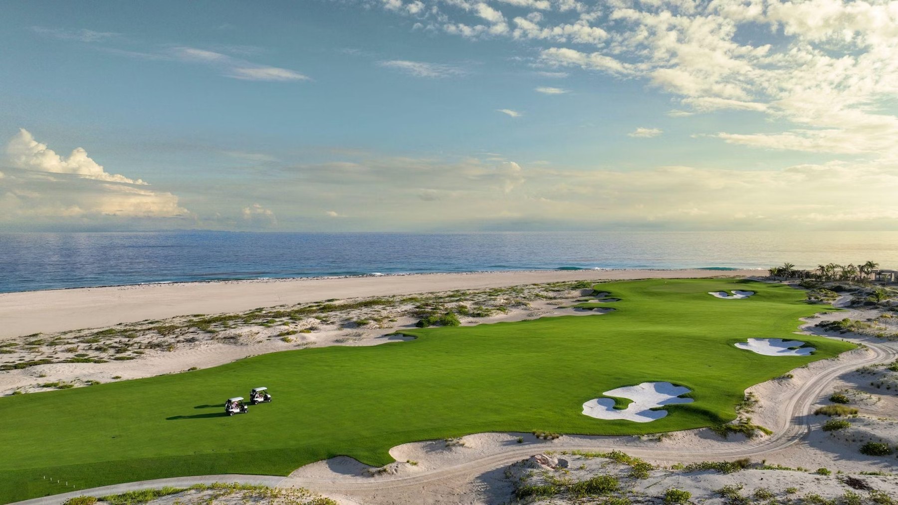 Barbuda Ocean Club golf fairway running beside white sand dunes and the open ocean
