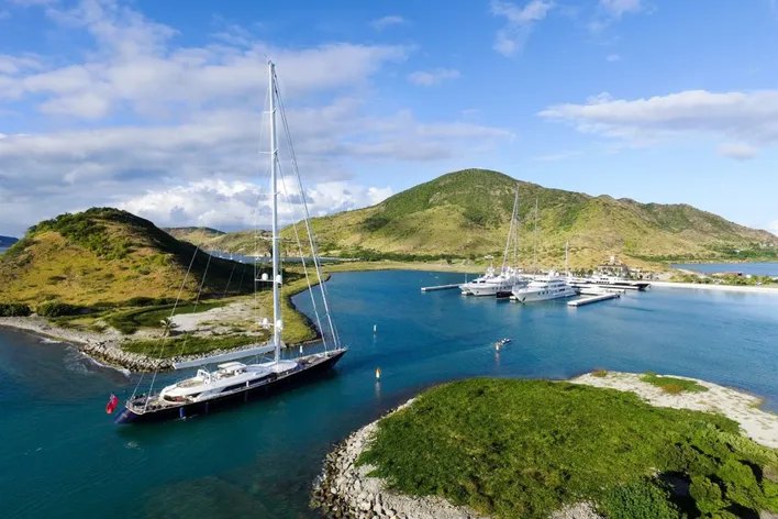 Large sailing yacht transiting the entrance channel into Christophe Harbour marina, St Kitts