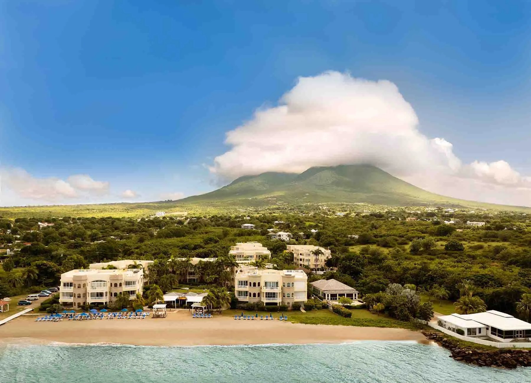 Aerial of Hamilton Beach Villas on Pinney's Beach with cloud-capped Nevis Peak beyond