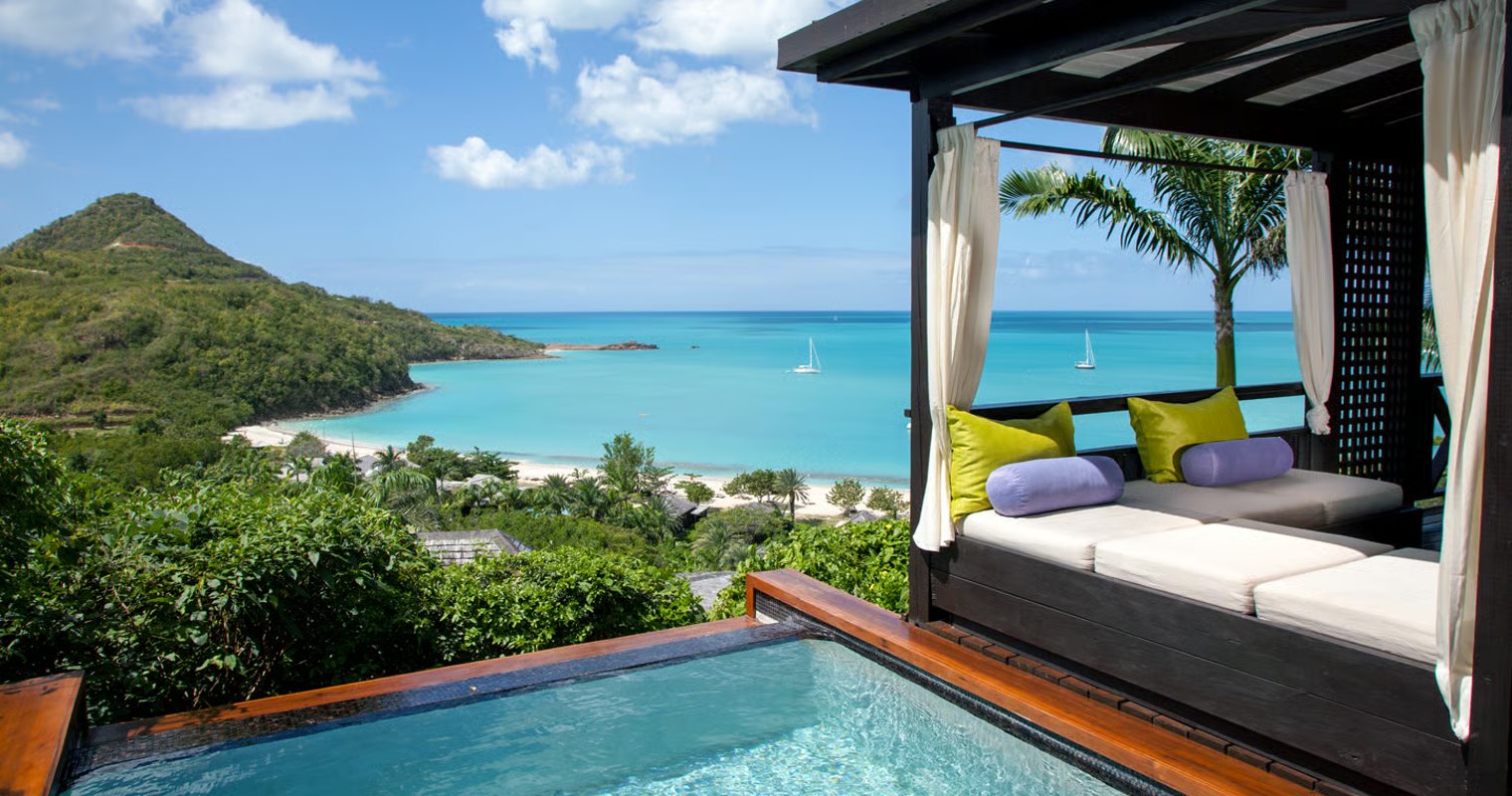 Private plunge pool and shaded daybed overlooking Hermitage Bay's turquoise water, Antigua