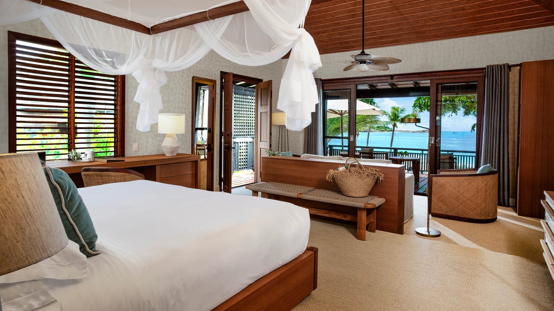 Canopied bed in a Hermitage Bay suite opening onto the beach, Antigua
