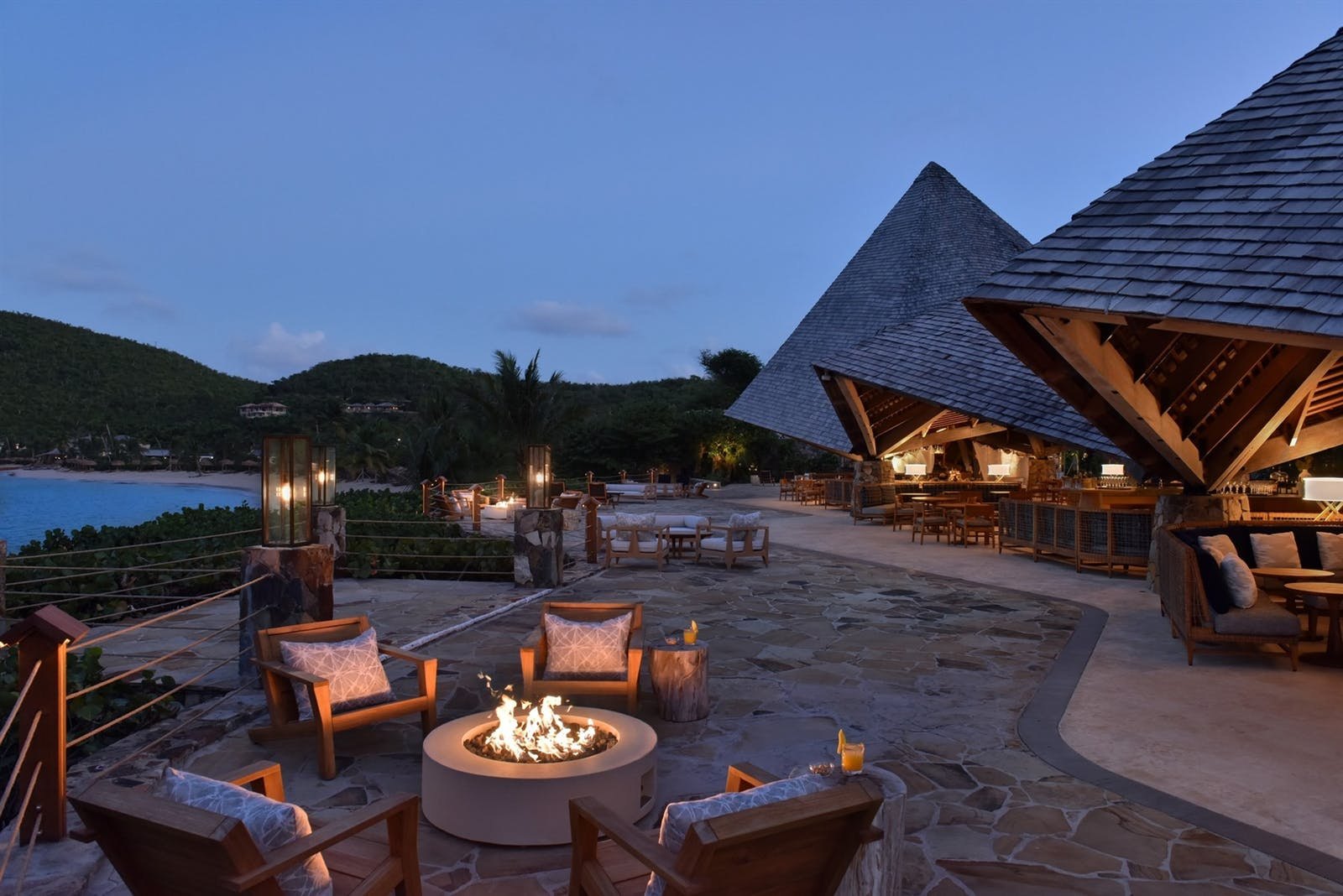 Terrace fire pit lit at dusk beside the pavilion at Little Dix Bay, Virgin Gorda