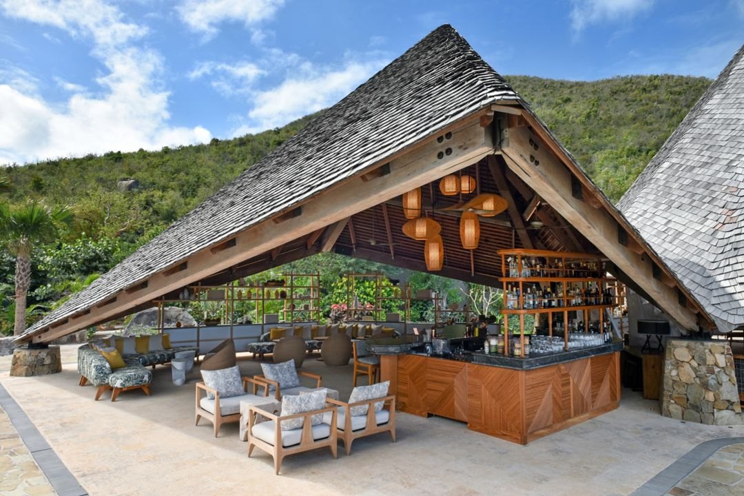 Open-air bar pavilion with shingled pyramid roof and timber frame, Little Dix Bay