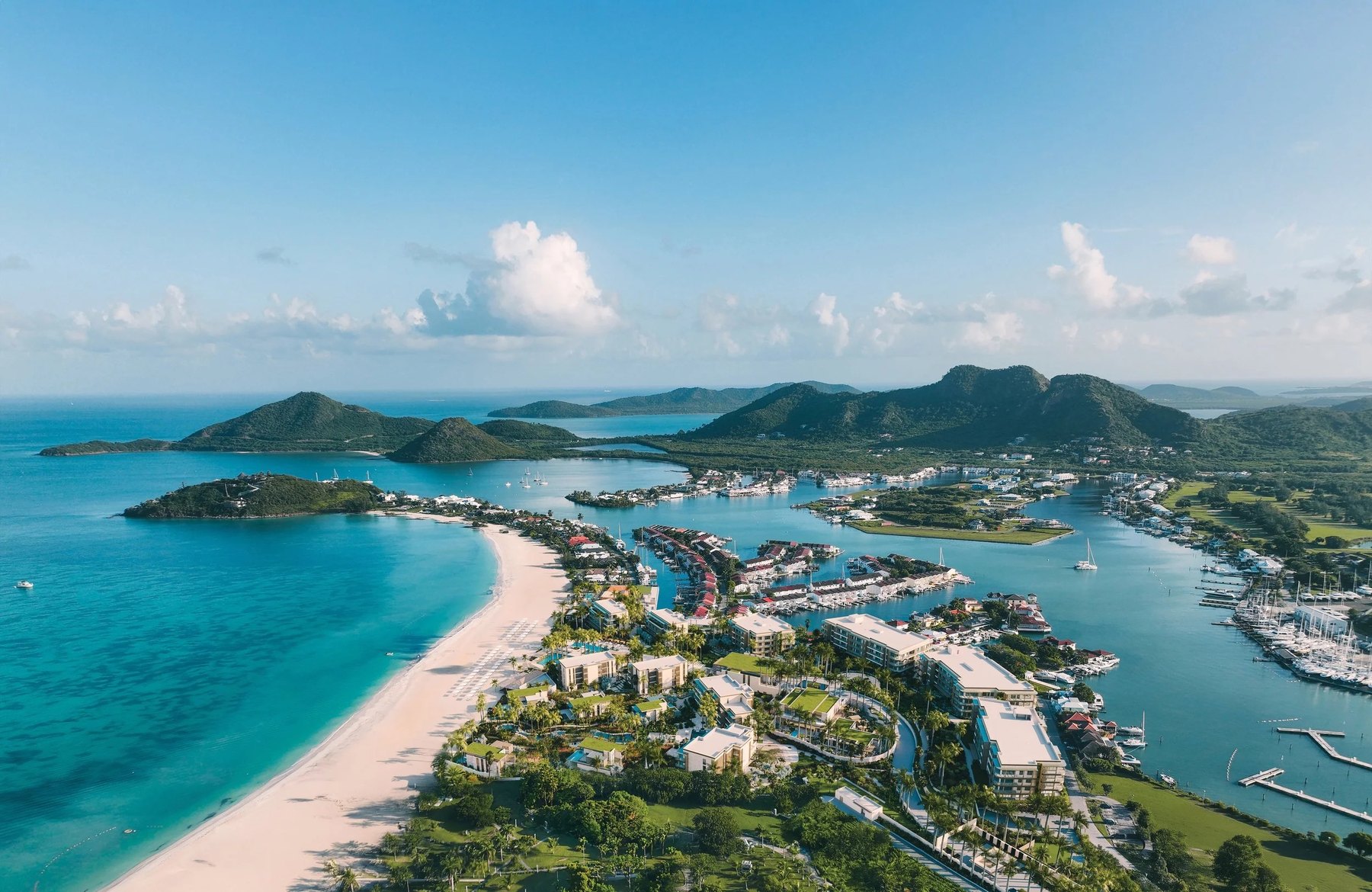 Aerial of Jolly Beach and Jolly Harbour marina, Antigua, white sand against turquoise water