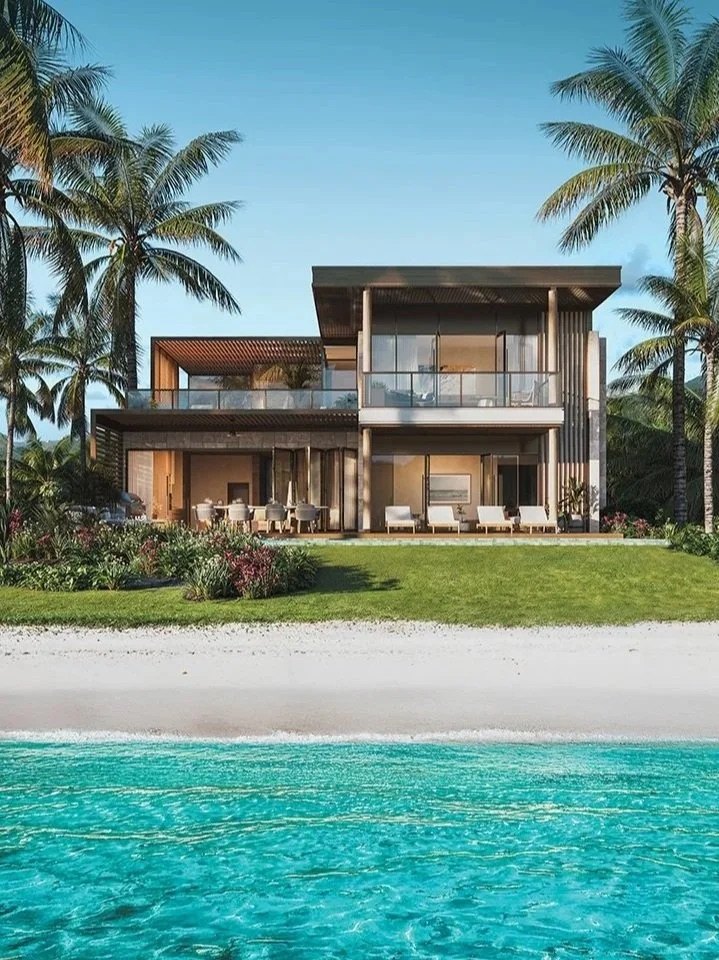 Artist's rendering of a two-storey beachfront villa behind white sand and shallow turquoise water