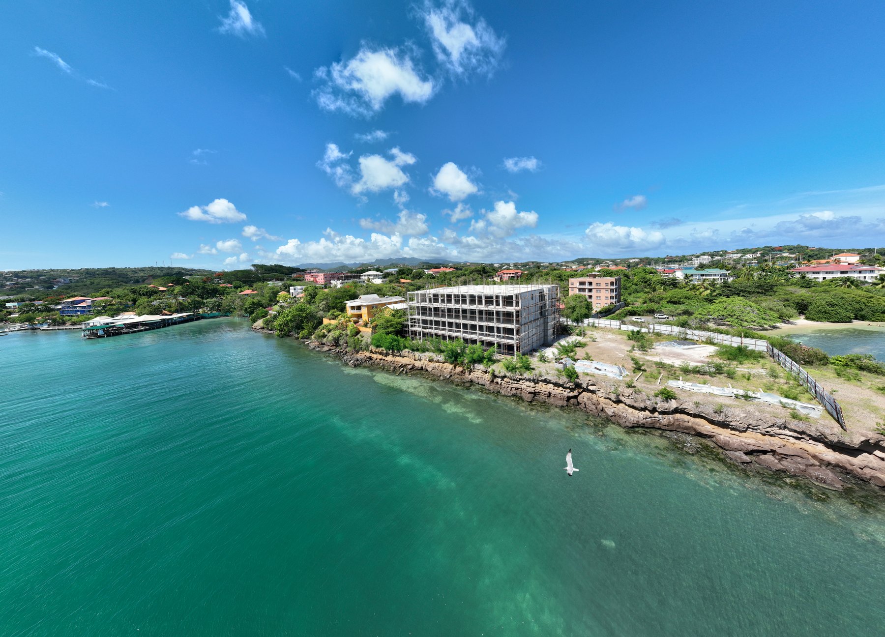 Aerial view of One True Blue rising on the headland above True Blue Bay, Grenada