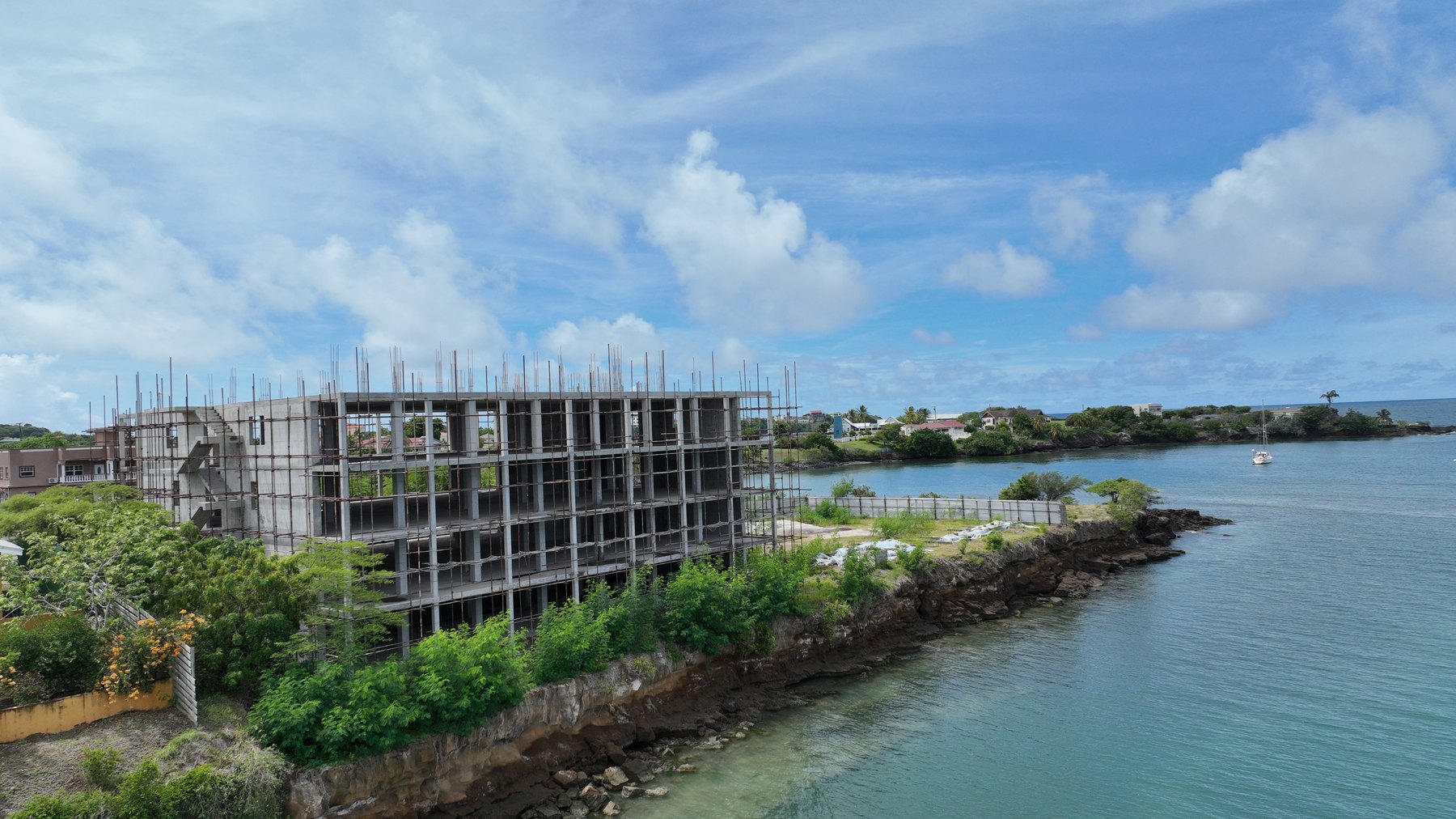 One True Blue's scaffolded structure on the rocky shoreline of True Blue Bay, Grenada
