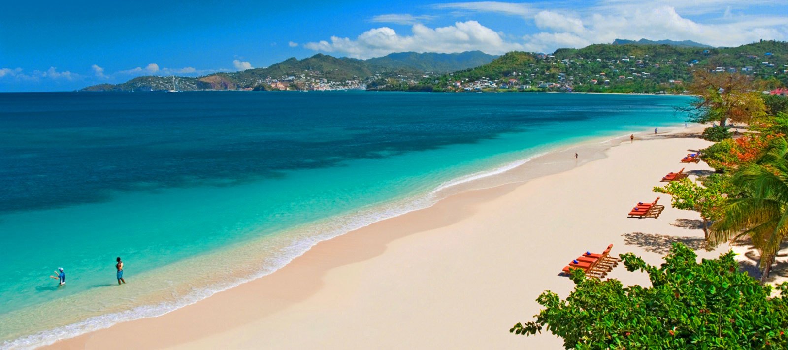 Grand Anse Beach near True Blue Bay, Grenada, with loungers under seagrape trees