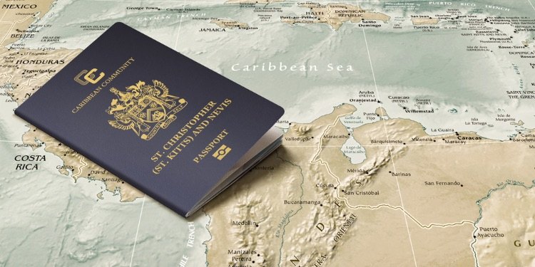 A navy passport stands upright on a printed map of the Caribbean Sea
