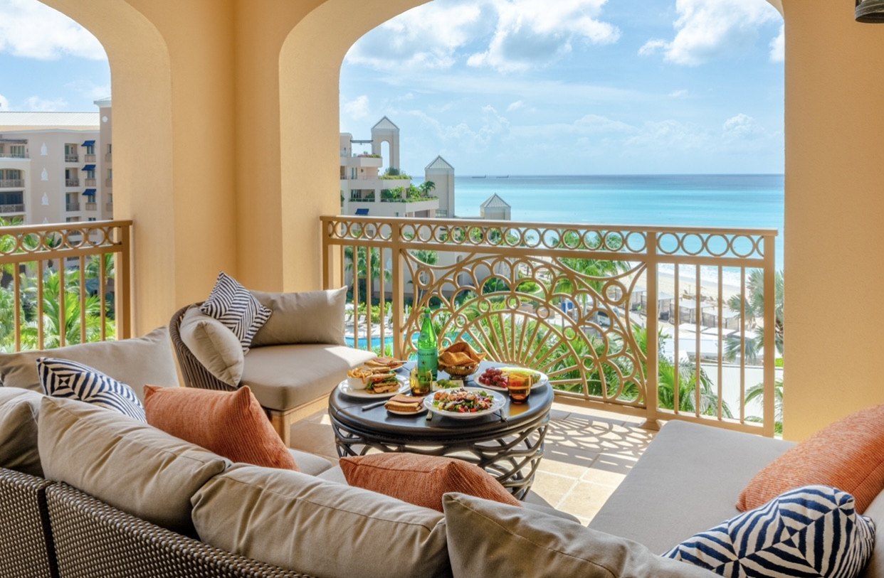 Furnished arched terrace with lunch overlooking Seven Mile Beach, Ritz-Carlton Residences, Grand Cayman