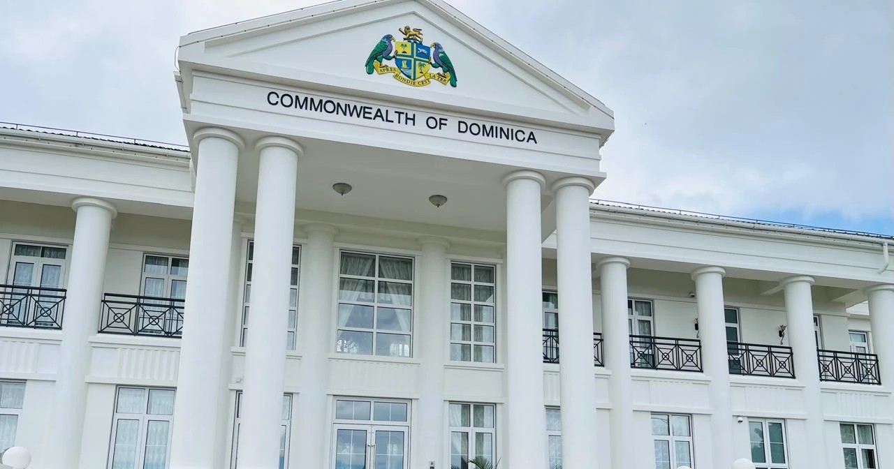 The portico of a government building in Roseau, its pediment carrying the Commonwealth of Dominica coat of arms and the national motto