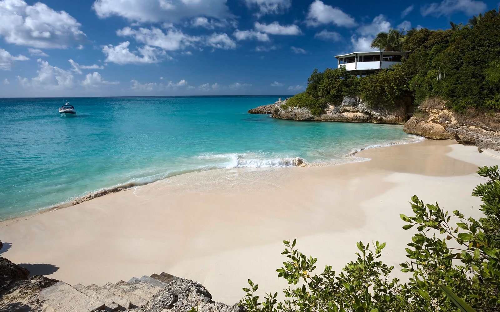 Aerial view of white cliffside villas and turquoise bays on Anguilla's northwest coast