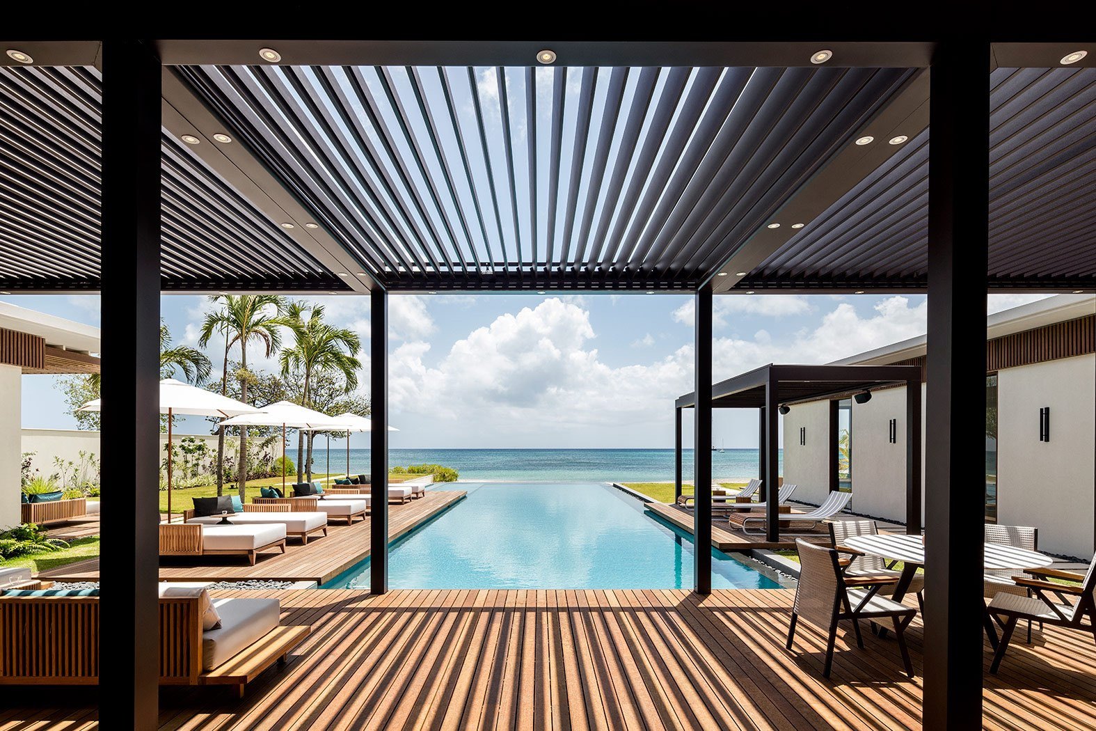 Louvred pavilion framing the infinity pool and Caribbean Sea at Silversands, Grand Anse Grenada