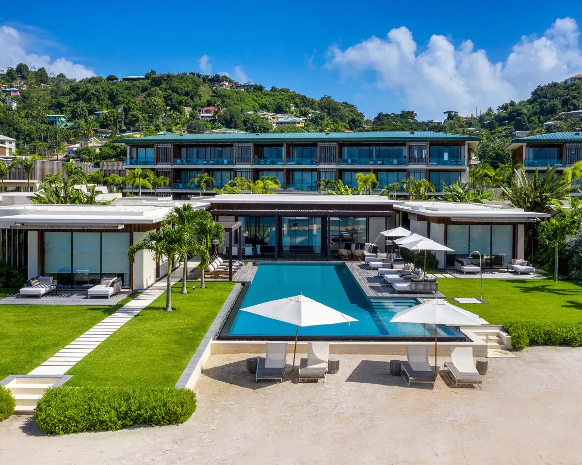 Elevated view of Silversands beachfront villa, pool and hotel wings above Grand Anse beach
