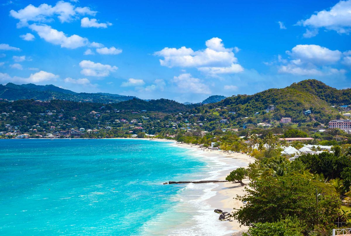 Golden-hour view of a Silversands Grand Anse beachfront villa and long infinity pool
