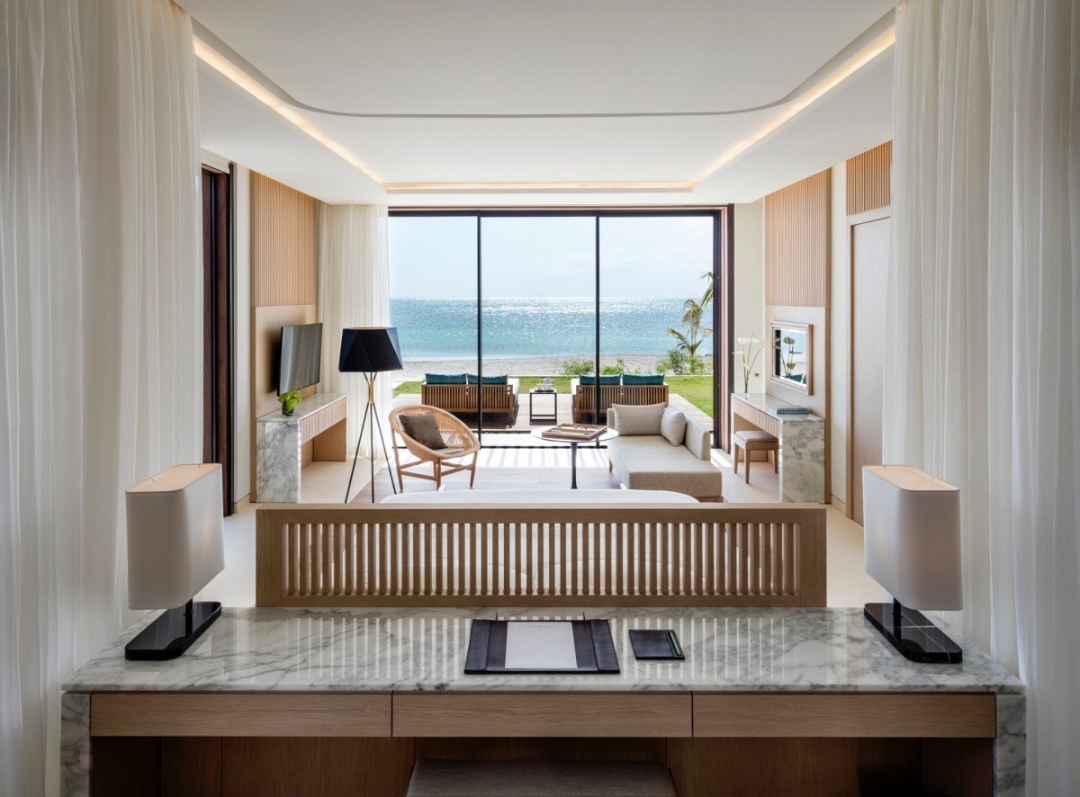 Silversands Grenada suite with marble desk, curtained bedroom and framed view of Grand Anse