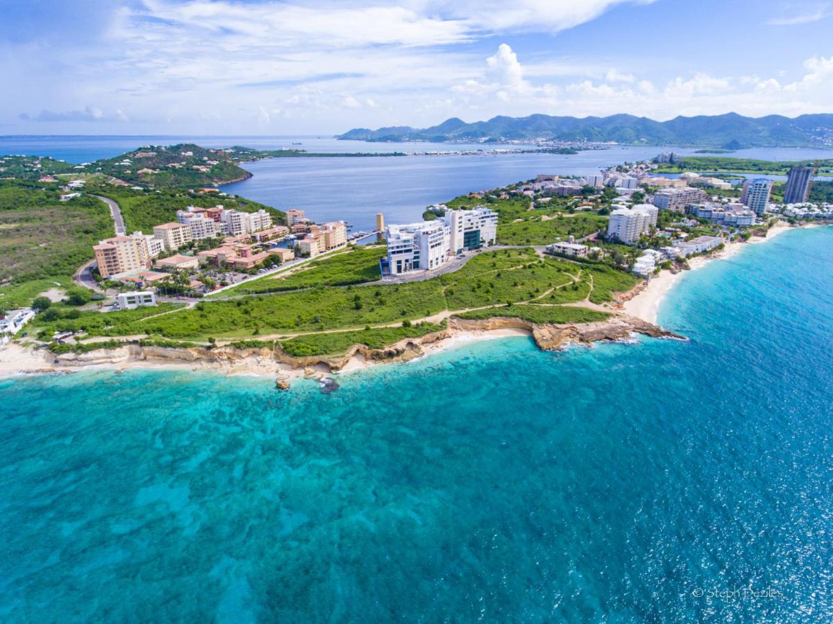 Artist's rendering of The Setai Sint Maarten resort curving above Indigo Bay's beach and turquoise sea