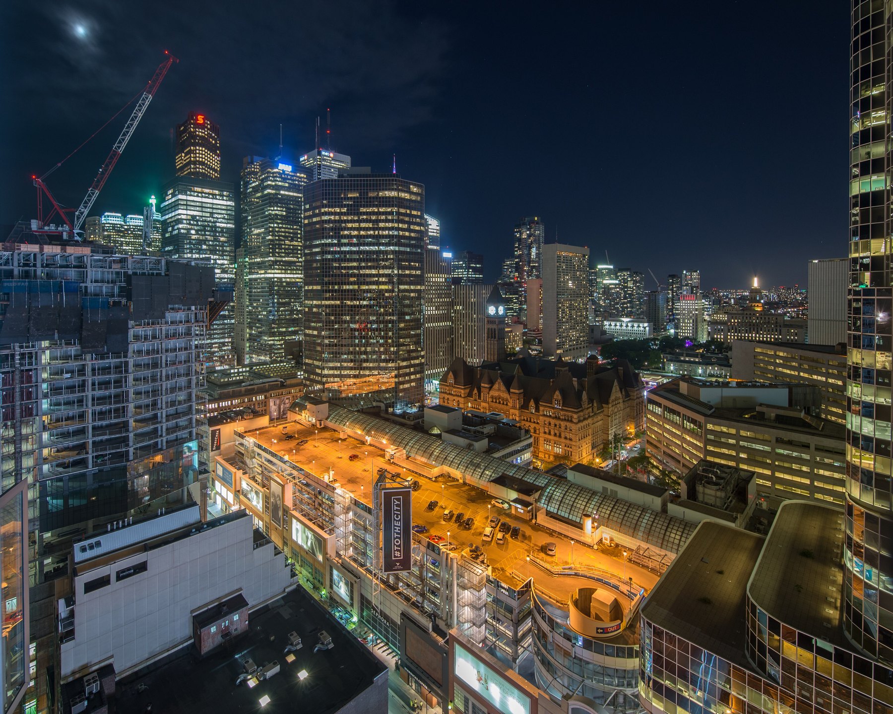Aerial night view of downtown Toronto towers and the illuminated old city hall