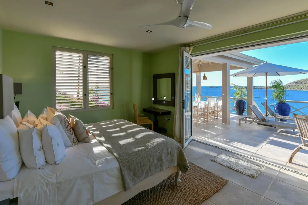 A green bedroom opening to the terrace