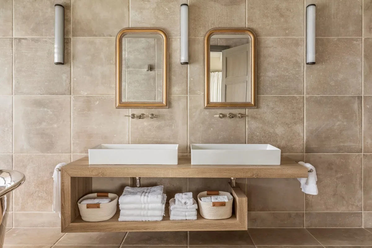 Twin vanities under arched mirrors