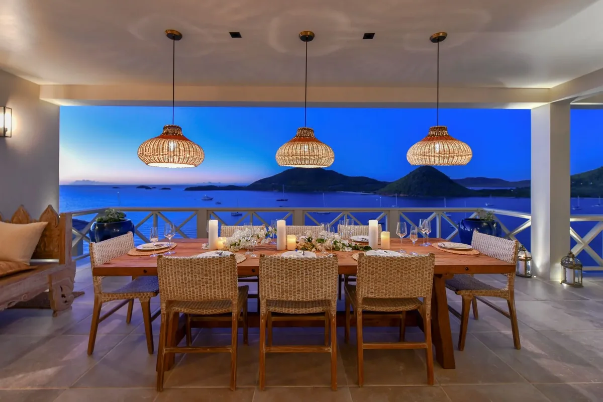 The terrace table laid for dinner at dusk