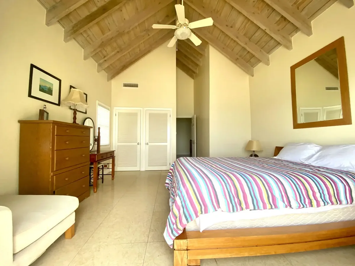 A bedroom under a vaulted ceiling