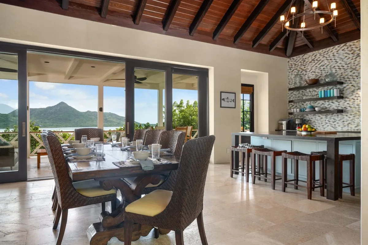 The dining table and open kitchen beyond
