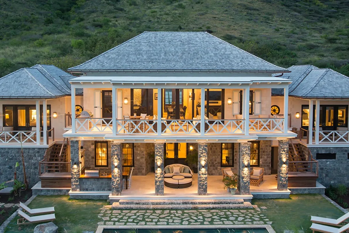 The villa facade lit at dusk