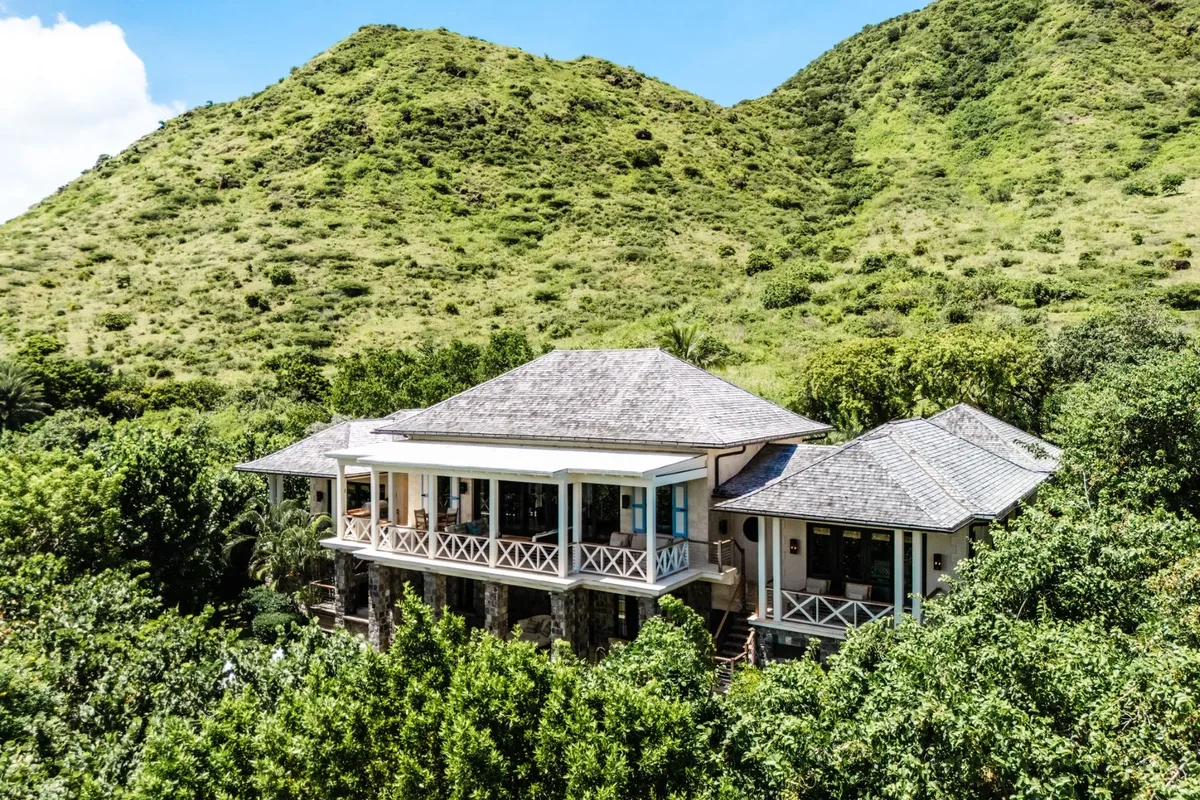 The villa set into the green hills