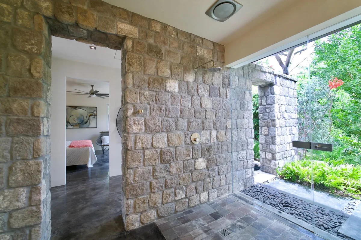 A stone wall through the centre of the villa