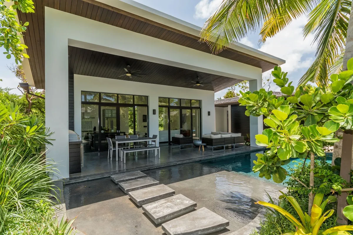 The villa and pool framed by palms