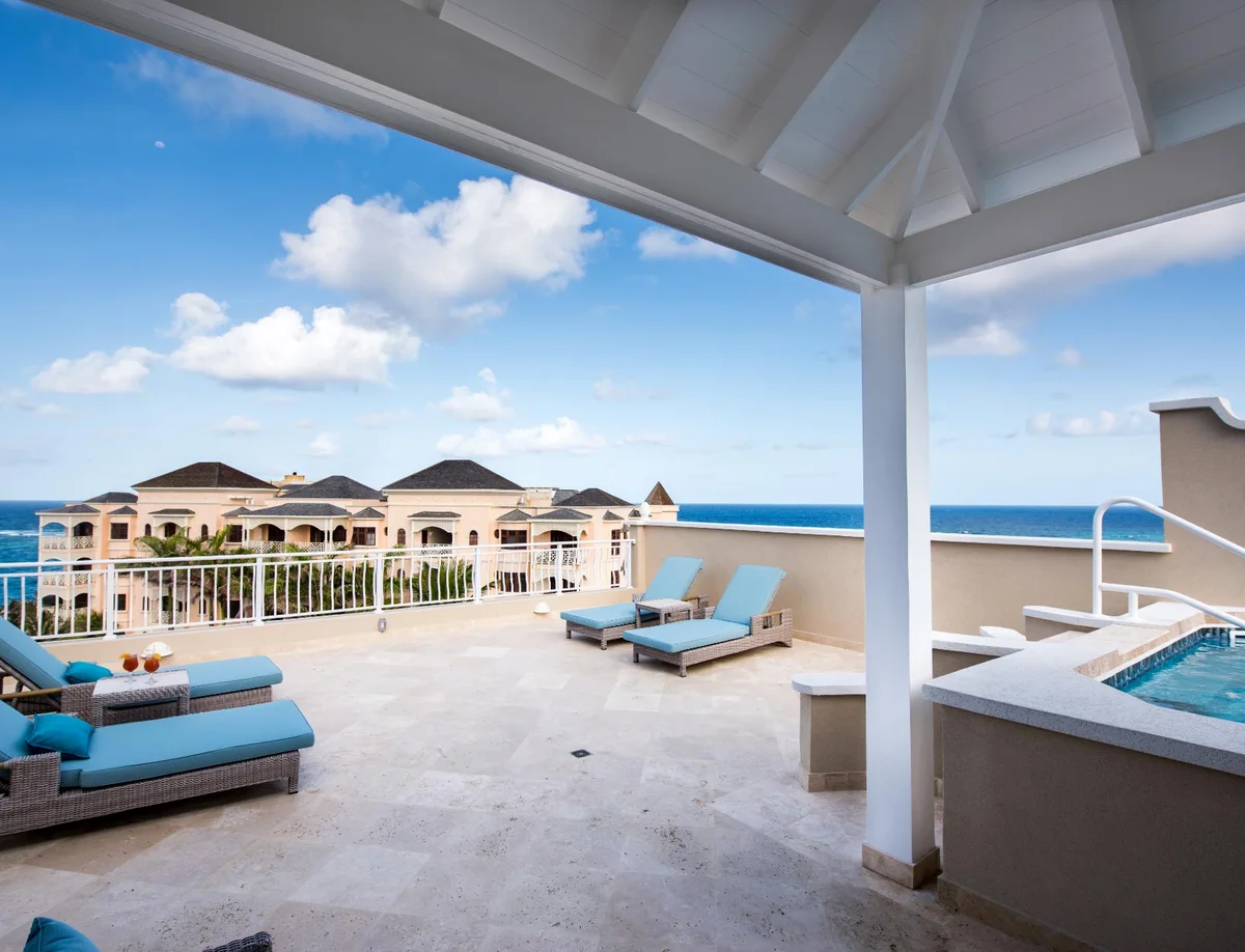 Photo of a private roof terrace on a built unit: tiled plunge pool/jacuzzi at right under a white timber-lined