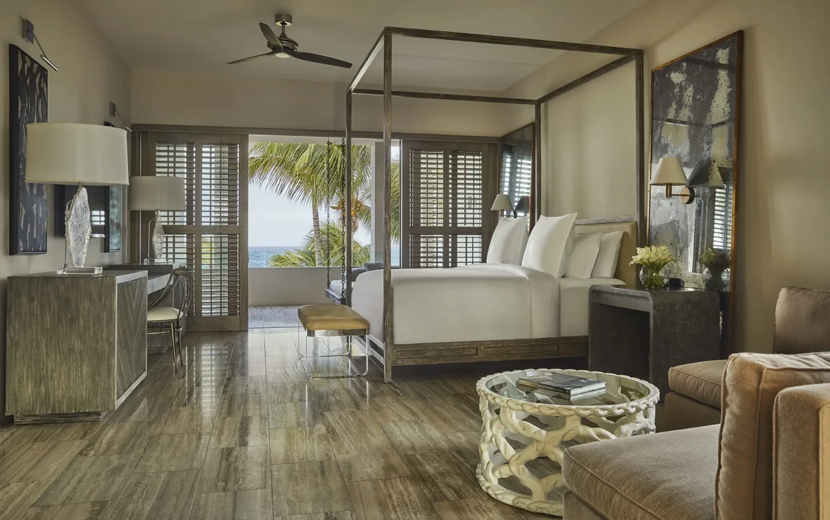 A bedroom with a canopy bed and sea view