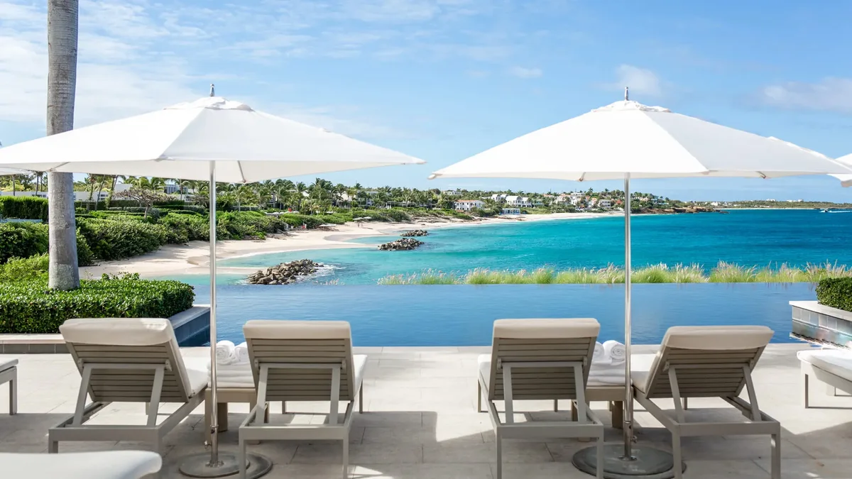 Loungers and umbrellas above the bay