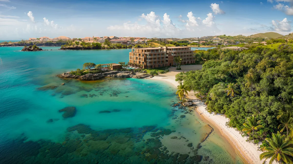 Artist’s rendering of aerial of the hotel on the headland — beach, turquoise reef flats, town on the far shore. 2560x1436, the