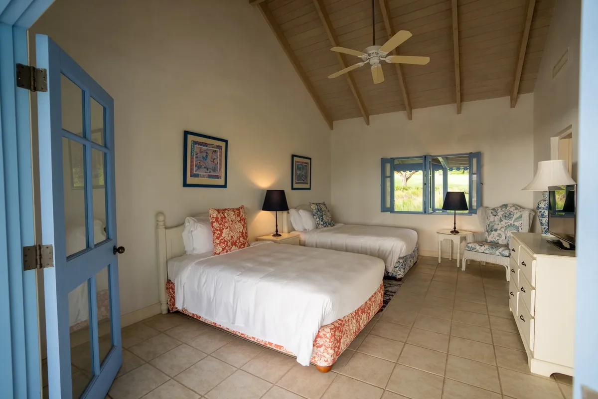 A twin bedroom with blue doors