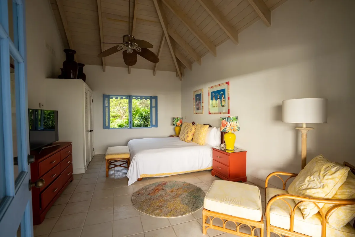 A bedroom with rattan seating