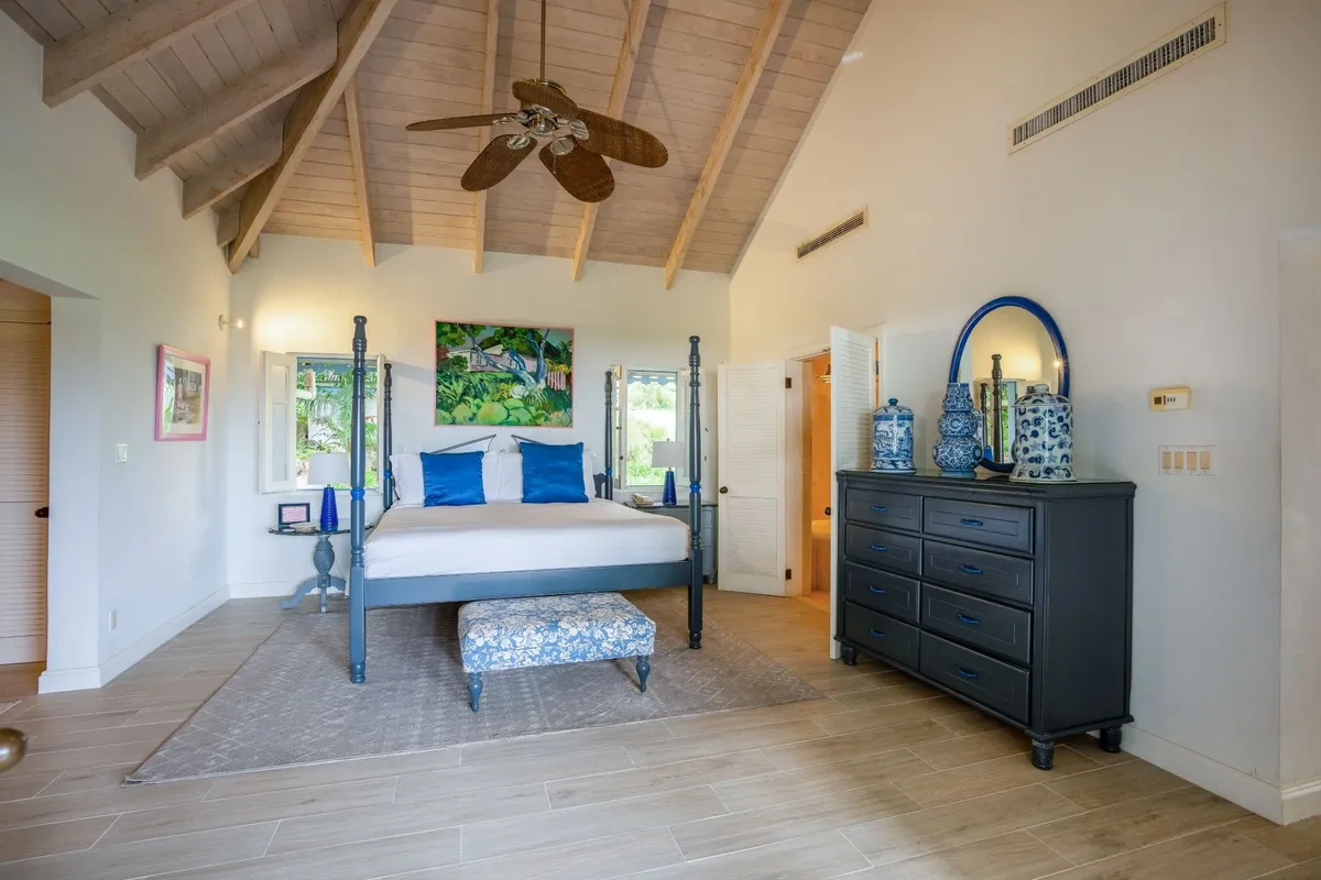 A bedroom with a blue four-poster
