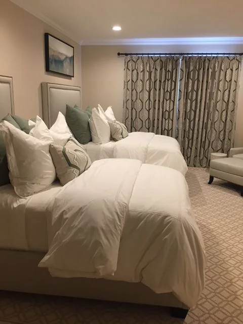 a bedroom looking toward the curtained window