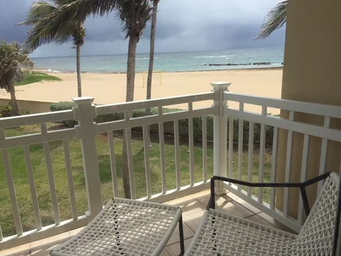 the balcony, looking over the lawn to the beach