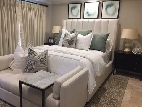 a bedroom with king bed and bench