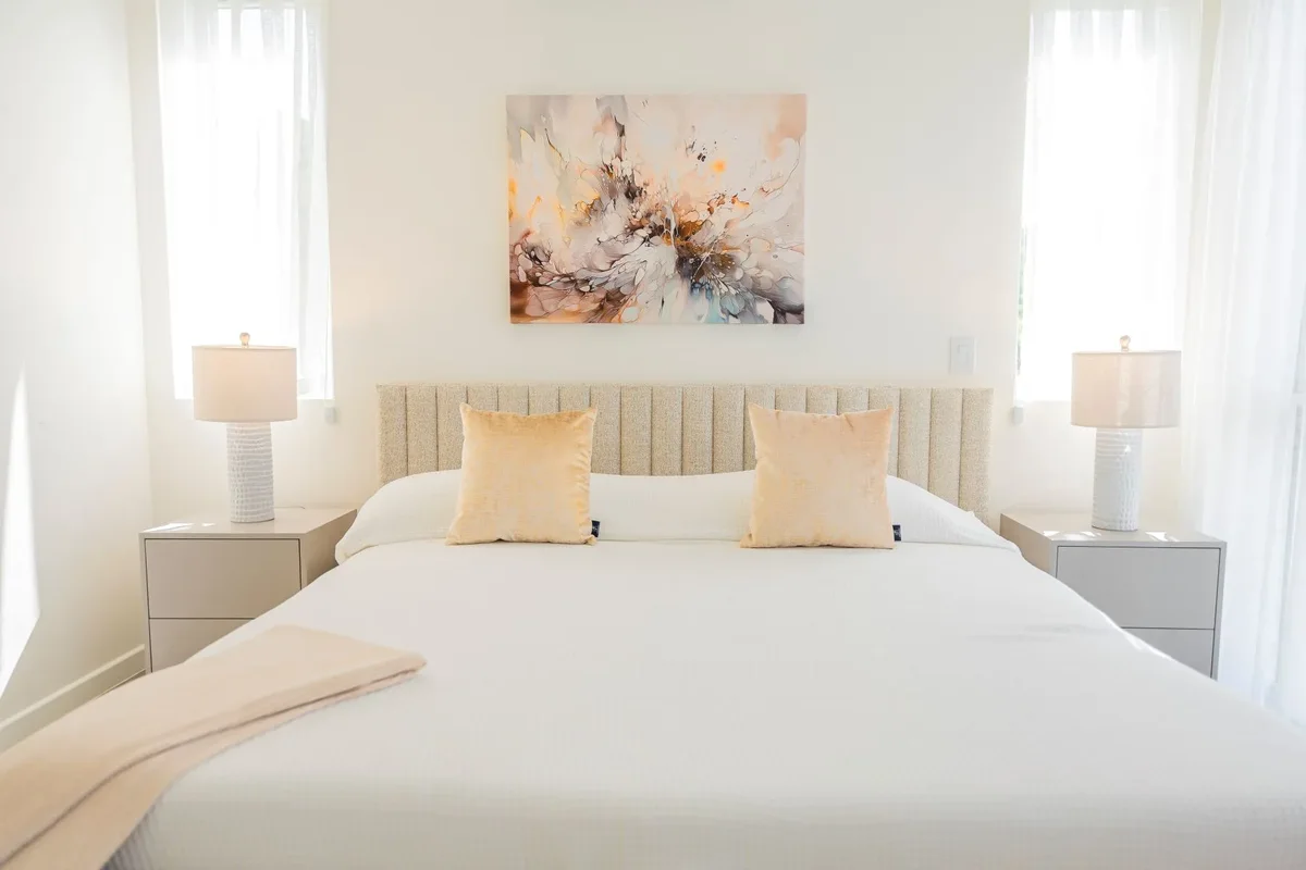 A bedroom with an upholstered headboard