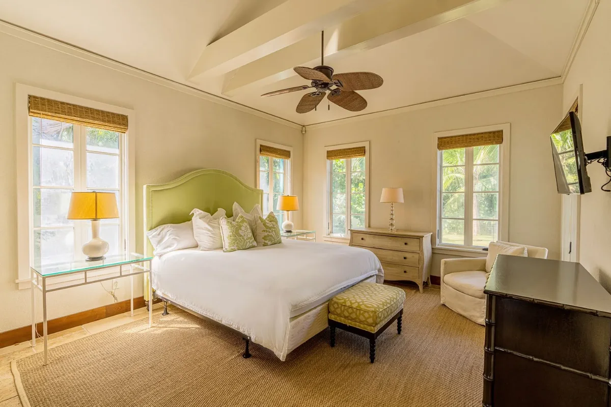 A bedroom with a king bed and bench